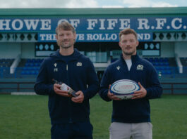 The Famous Grouse backs grassroots rugby with competition Members of the Howe of Fife RFC team stand on a rugby pitch holding a rugby ball as well as a bottle of The Famous Grouse.